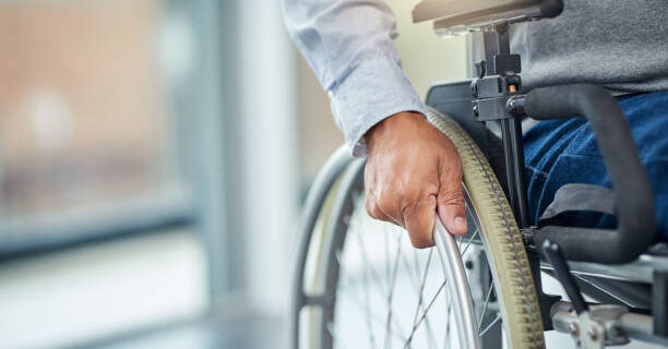 Cropped shot of an unrecognisable senior man in a wheelchair Cropped shot of an unrecognisable senior man in a wheelchair