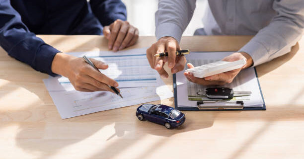 istockphoto-1456102192-612x612 Dealer salesman giving car key to owner. client signing insurance document or rental car lease form agreement contract Insurance car concept.
